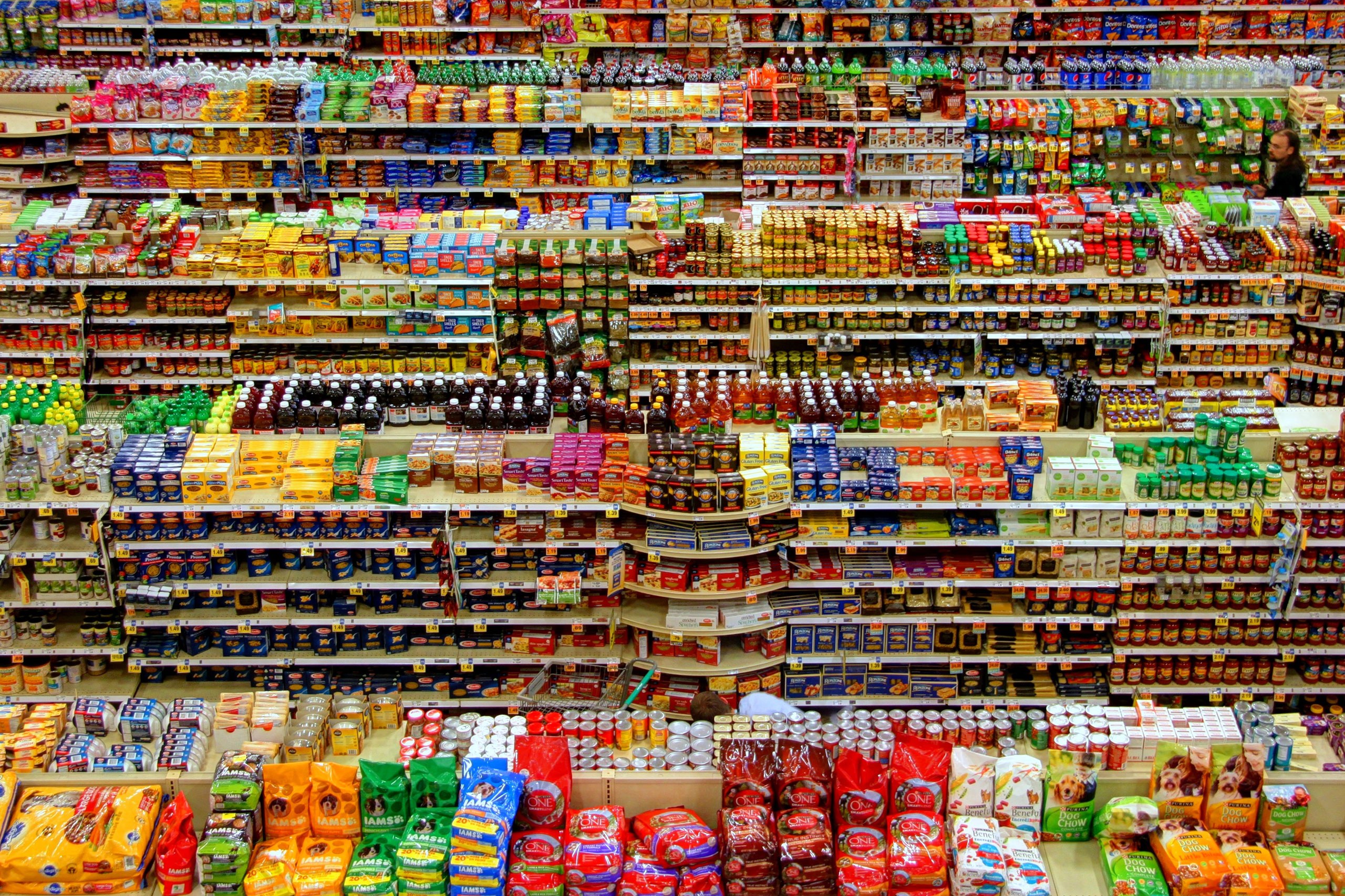 Busy and colourful shelves in a shop full of varied products.
